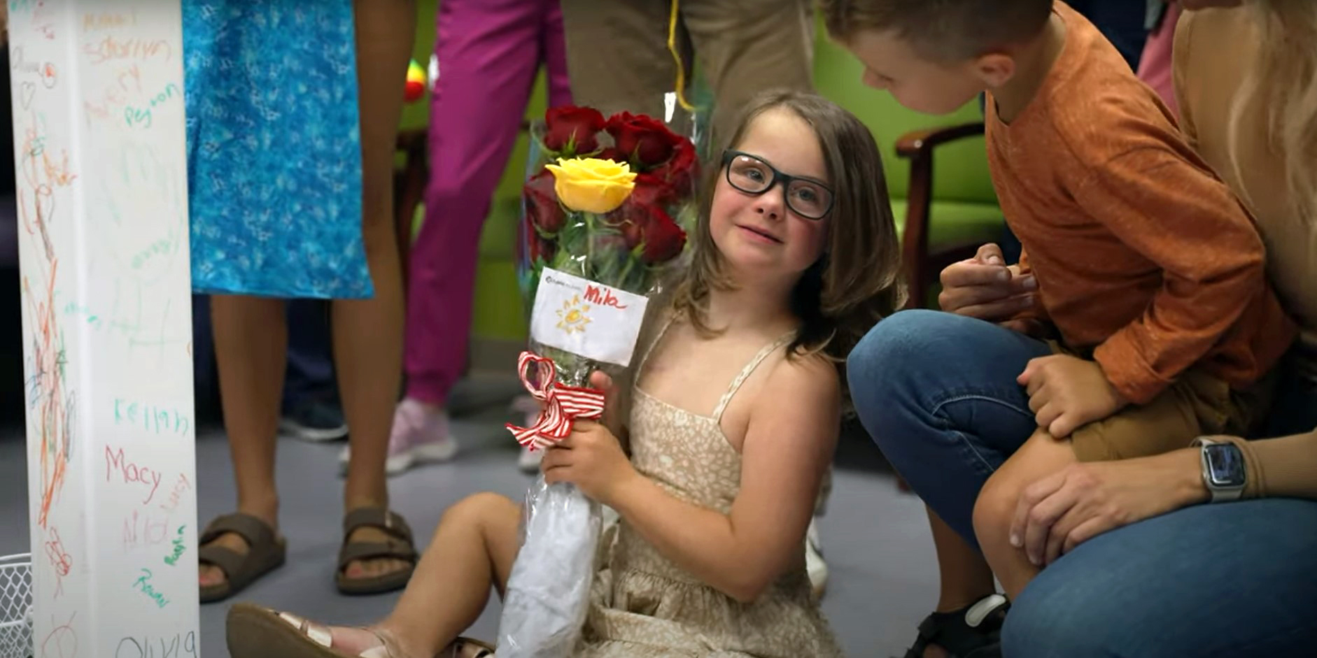 Little girl holding flowers looking at the camera.jpg