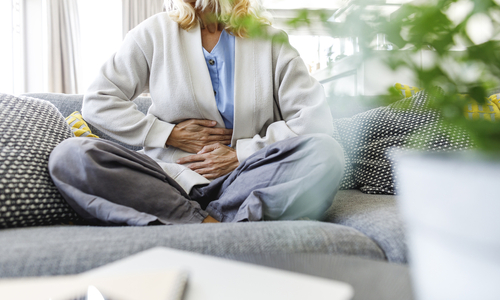 Woman holding hands over abdomen.jpg