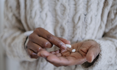 Woman holding a pill.jpg